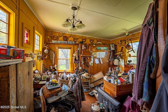 misc room featuring wooden walls and ornamental molding