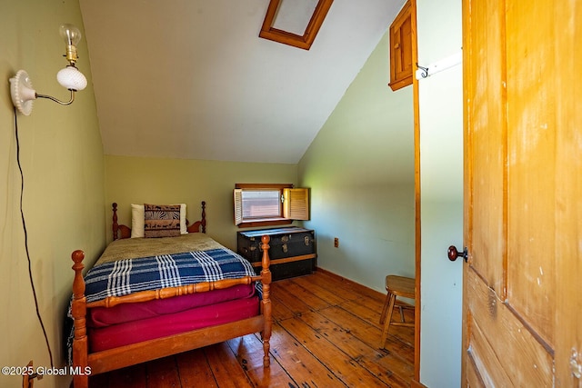 bedroom featuring vaulted ceiling and hardwood / wood-style floors