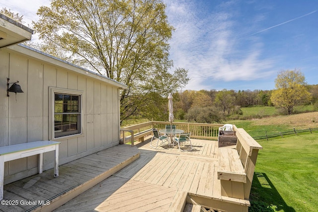 deck featuring a yard and outdoor dining space
