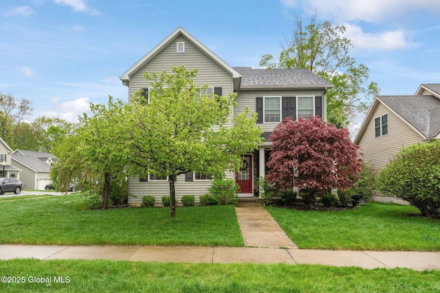 traditional-style house with a front lawn and a shingled roof