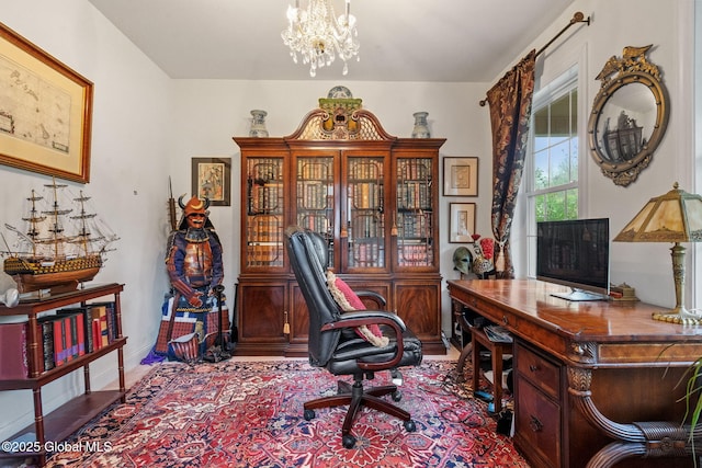 office space with a chandelier and baseboards