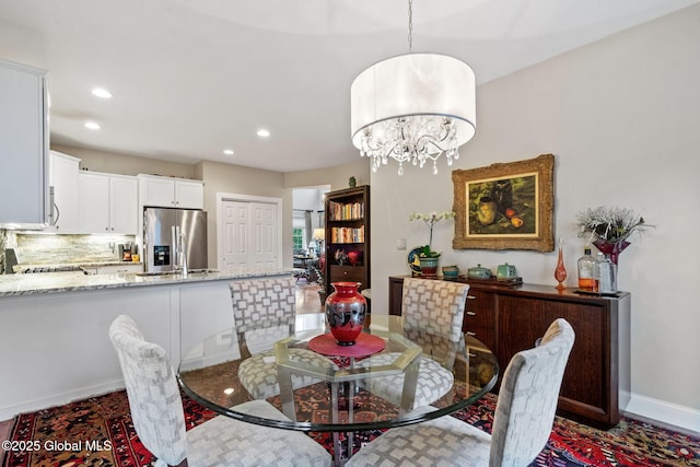 dining area featuring recessed lighting, a chandelier, and baseboards