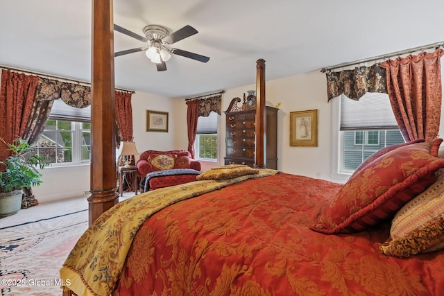 carpeted bedroom featuring multiple windows and ceiling fan