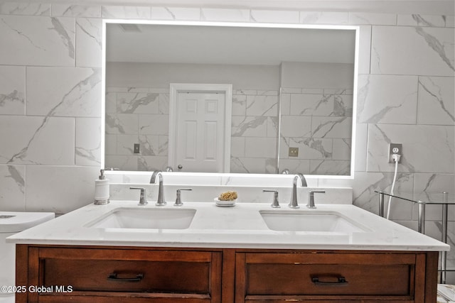 full bath with tile walls and double vanity