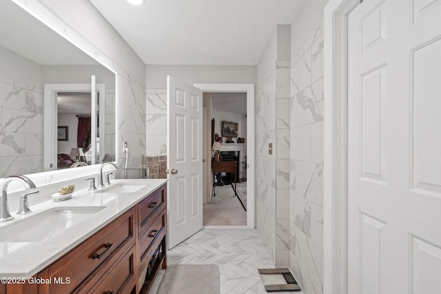 ensuite bathroom with double vanity and tile walls
