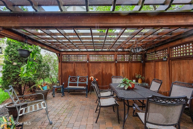view of patio featuring a pergola, outdoor dining area, and fence