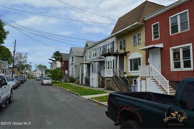 view of road featuring curbs, sidewalks, and a residential view