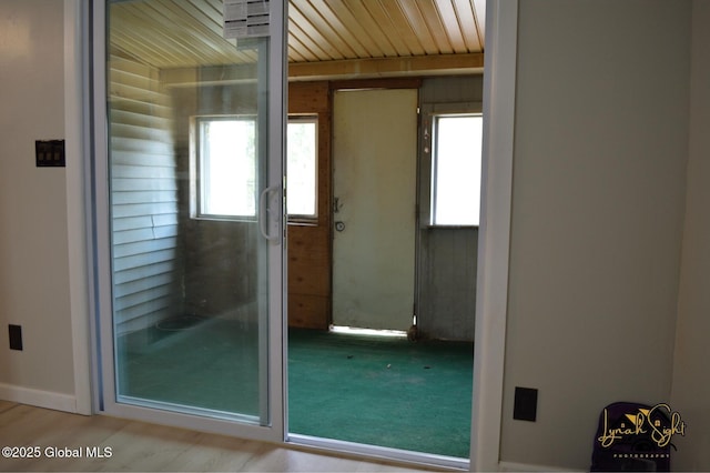 doorway to outside featuring wood ceiling