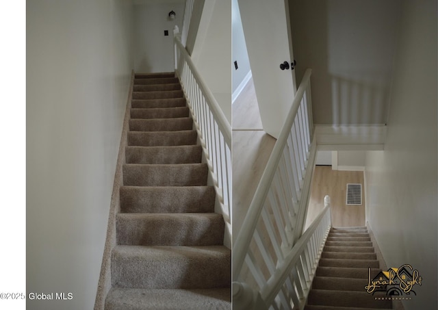 stairs with wood finished floors and visible vents