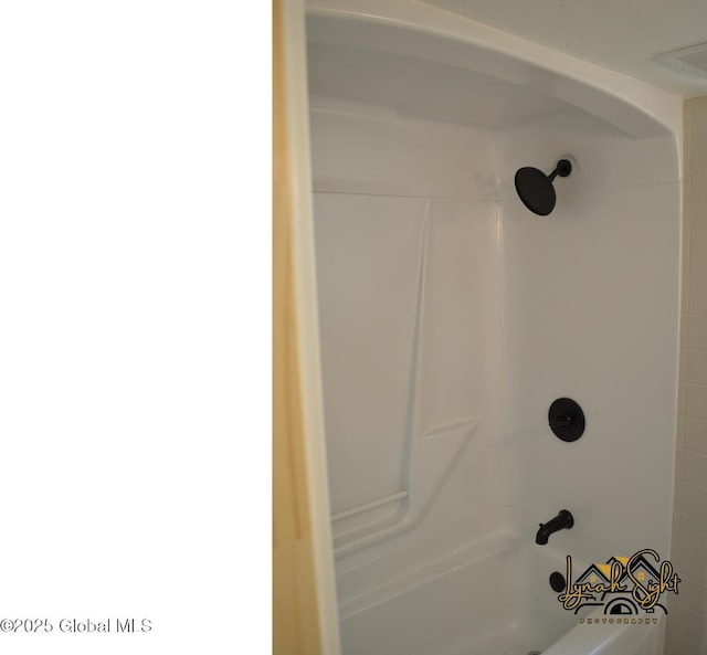 room details featuring shower / tub combination