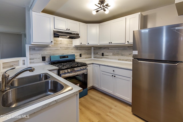 37 Nelson Ave, Rensselaer, NY 12144 - kitchen featuring stainless steel appliances, under cabinet range hood, a sink, and white cabinets