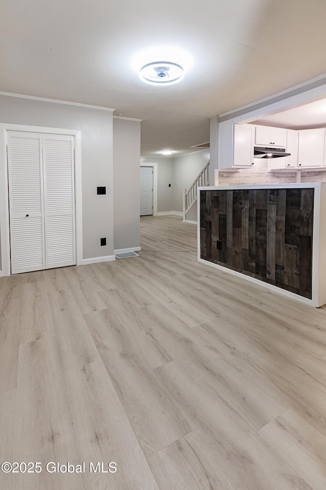 37 Nelson Ave, Rensselaer, NY 12144 - unfurnished living room featuring stairs, baseboards, and light wood-type flooring