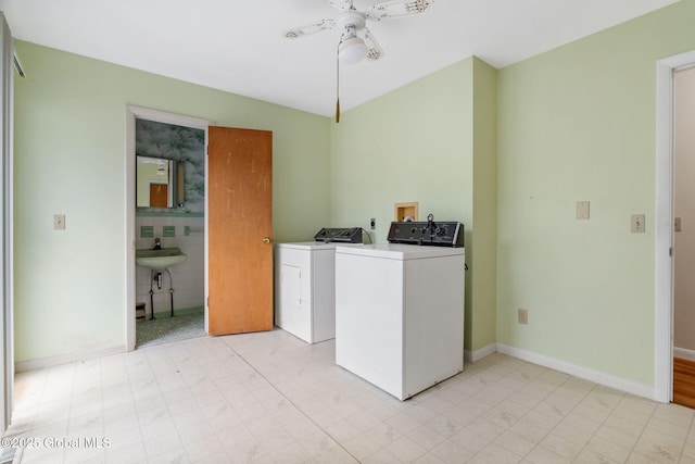 laundry area with washer and dryer, ceiling fan, baseboards, and light flooring