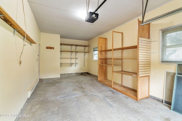 garage with a garage door opener and a baseboard radiator