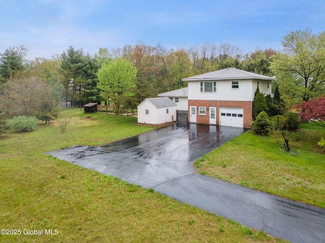 view of front of house featuring asphalt driveway, an attached garage, brick siding, and a front lawn