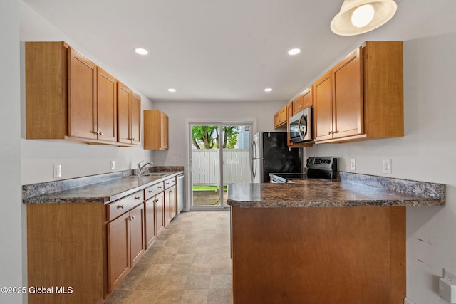 kitchen with a peninsula, recessed lighting, dark countertops, and appliances with stainless steel finishes