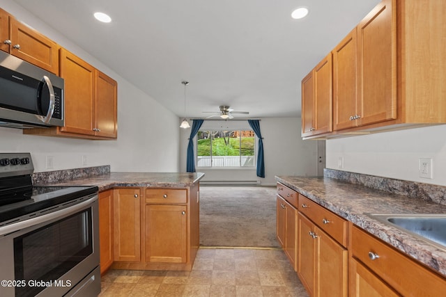 kitchen featuring dark countertops, brown cabinetry, ceiling fan, light carpet, and stainless steel appliances