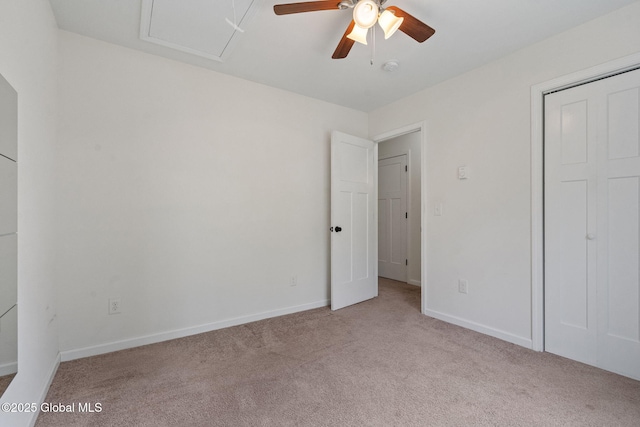 unfurnished bedroom featuring a closet, baseboards, ceiling fan, and carpet floors