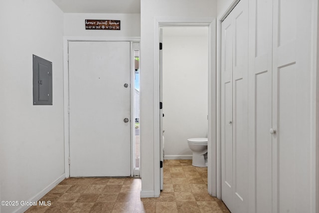entryway featuring electric panel and baseboards