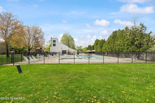 pool featuring a yard and fence