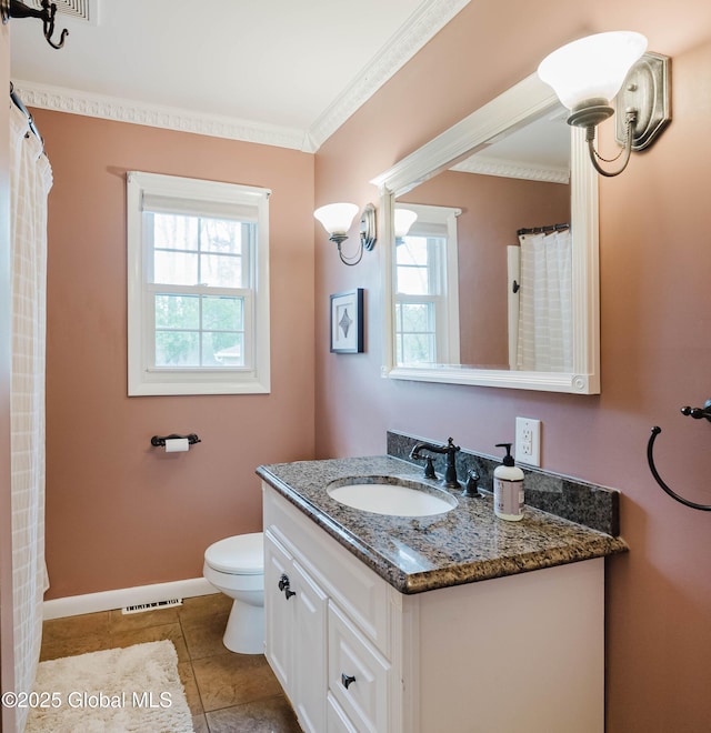 bathroom featuring vanity, ornamental molding, plenty of natural light, and visible vents