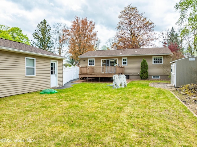 back of property featuring an outbuilding, a deck, fence, a shed, and a yard