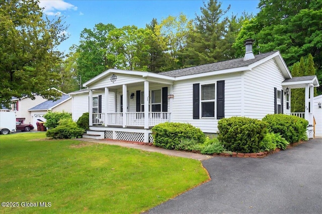 23 Hilton Dr, Moreau, NY 12803 - view of front of property featuring covered porch, a front yard, and a chimney