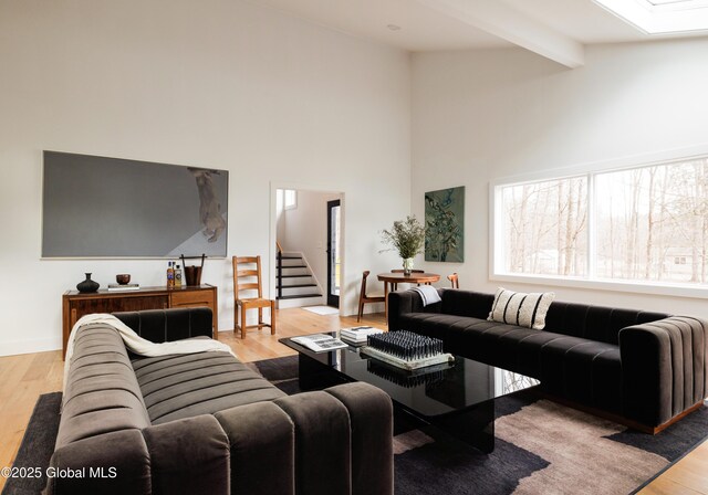 829 Jefferson Rd, Nassau, NY 12123 - living area with light wood finished floors, stairs, beamed ceiling, and high vaulted ceiling