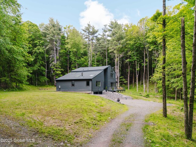829 Jefferson Rd, Nassau, NY 12123 - view of front of property with a deck, a front lawn, a forest view, and driveway