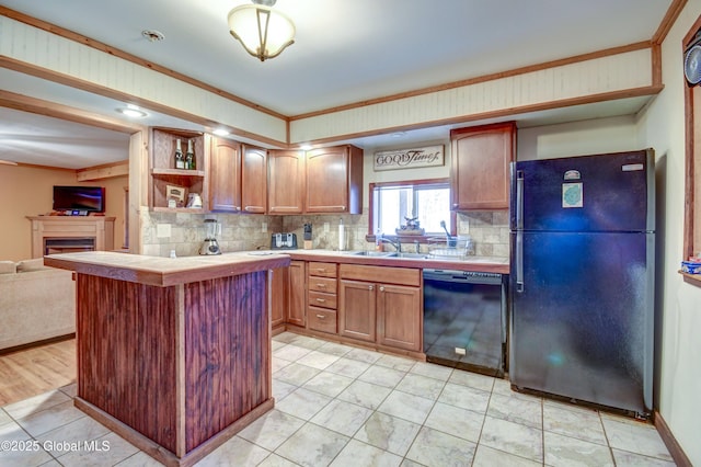 kitchen featuring black appliances, decorative backsplash, tile counters, crown molding, and open shelves