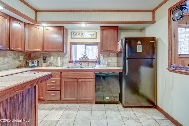 kitchen with black appliances, a sink, tile counters, decorative backsplash, and plenty of natural light