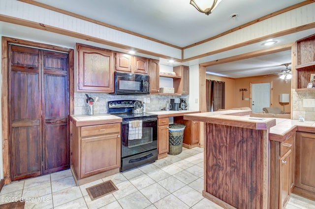 kitchen with black appliances, tile counters, open shelves, tasteful backsplash, and ornamental molding