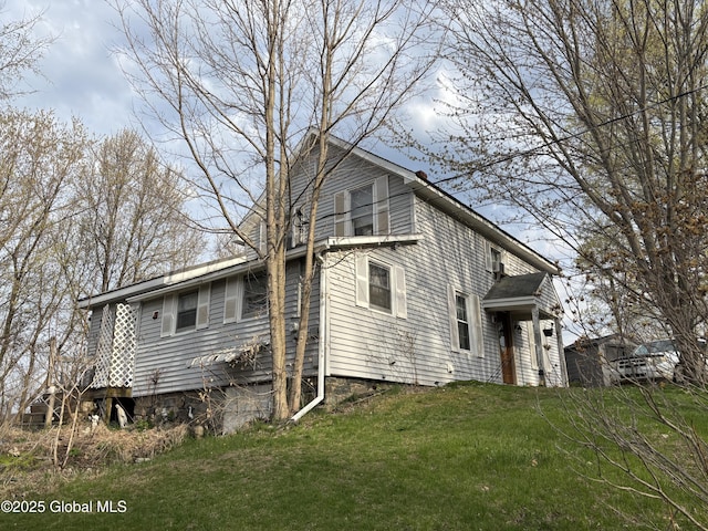 view of side of property with a yard