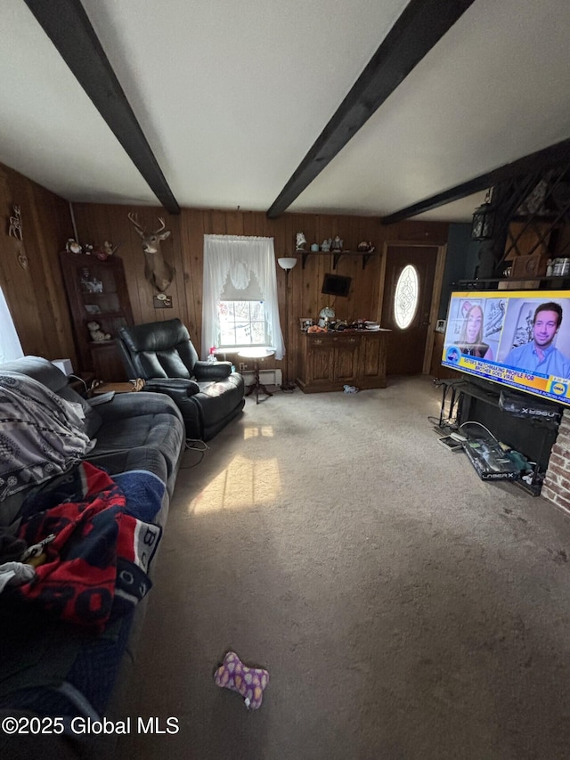 living area featuring carpet floors, beam ceiling, and wooden walls