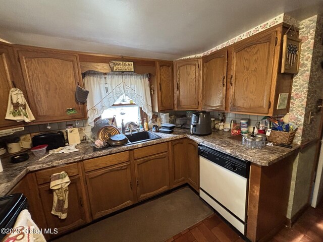 kitchen featuring backsplash, white dishwasher, and brown cabinets