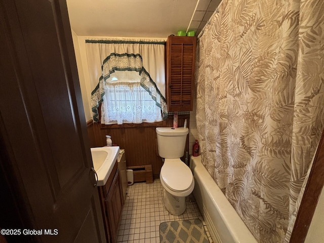 full bathroom with vanity, toilet, shower / bathtub combination with curtain, baseboard heating, and a wainscoted wall
