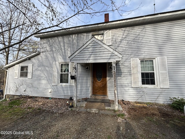 view of front of home featuring a chimney