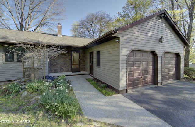 view of front of house featuring a garage and a chimney