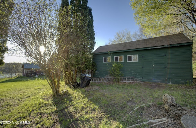 exterior space with a lawn and an outbuilding