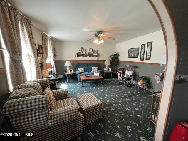 living area featuring carpet floors and ceiling fan