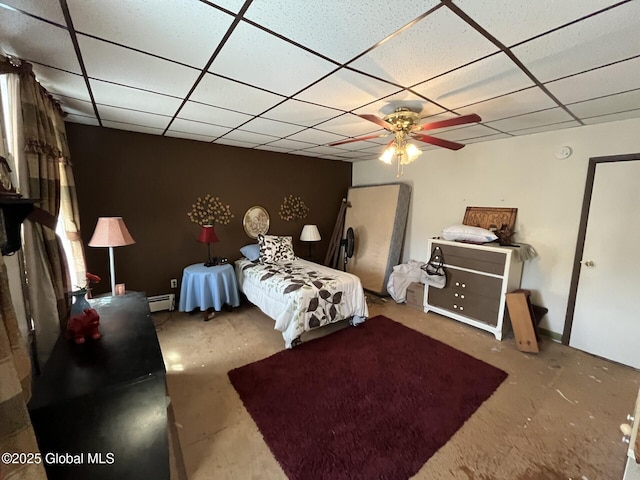 bedroom with baseboard heating and a paneled ceiling