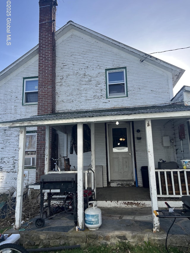10 Valley View Ln, Moriah, NY 12956 - view of front of home featuring a chimney and a porch