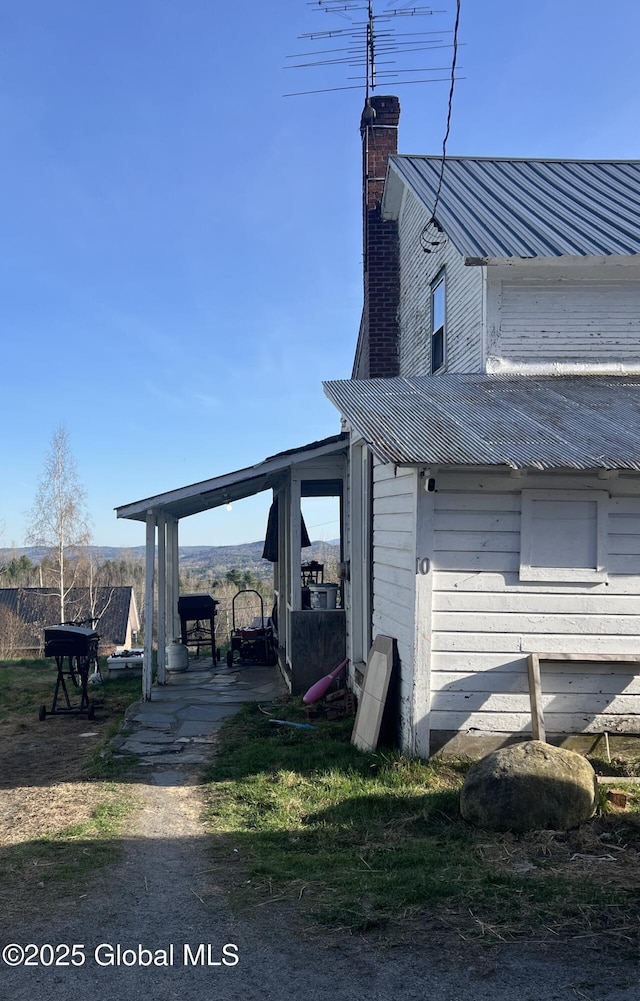 10 Valley View Ln, Moriah, NY 12956 - view of home's exterior with a chimney and metal roof