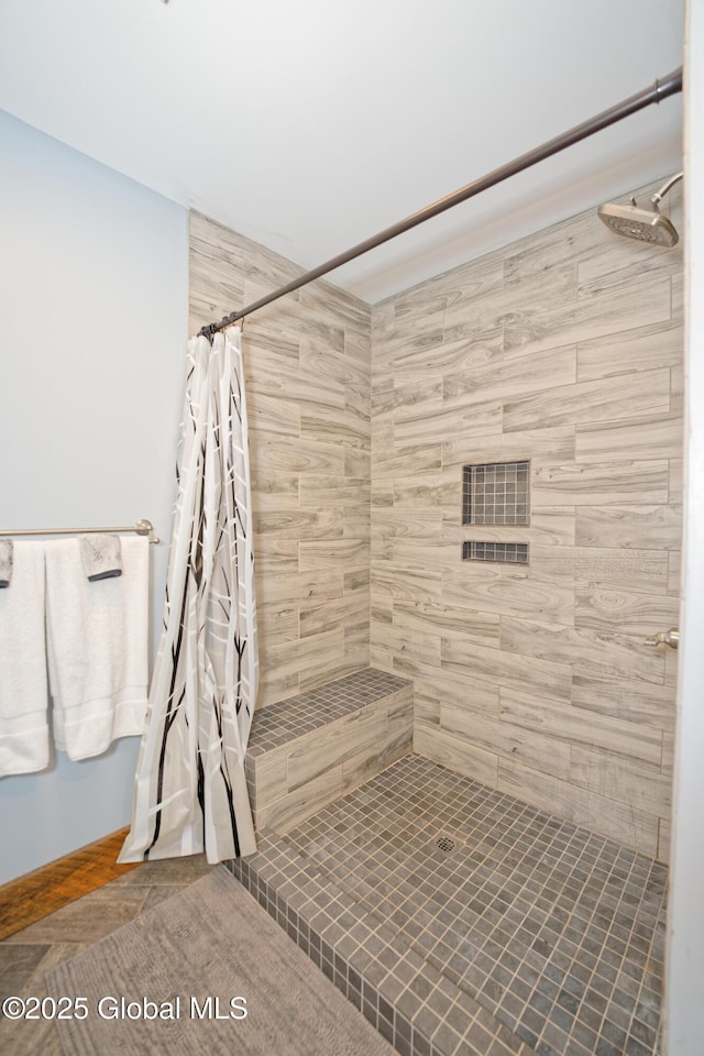 full bath with tiled shower