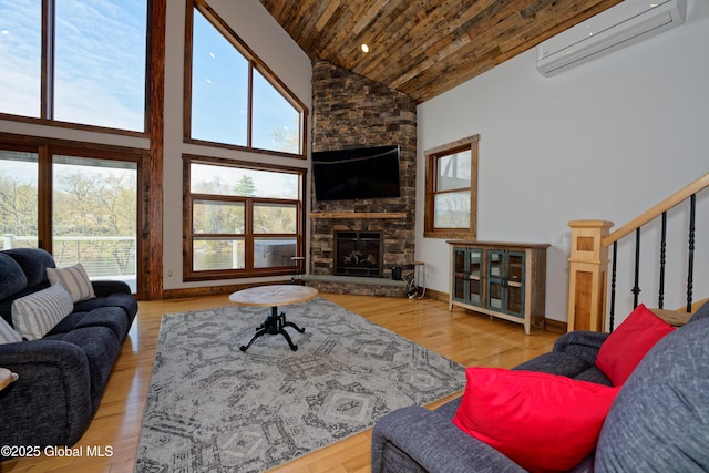 living room featuring high vaulted ceiling, a wall unit AC, a wealth of natural light, and wooden ceiling