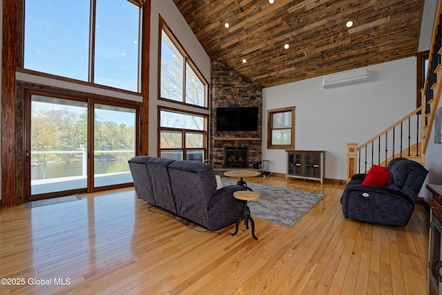 living room featuring wood ceiling, high vaulted ceiling, light wood-style flooring, and a wall mounted air conditioner