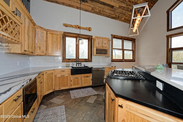 kitchen with built in microwave, dishwasher, a sink, high vaulted ceiling, and light brown cabinets