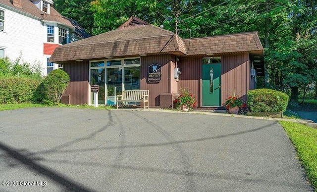 view of front of house featuring roof with shingles