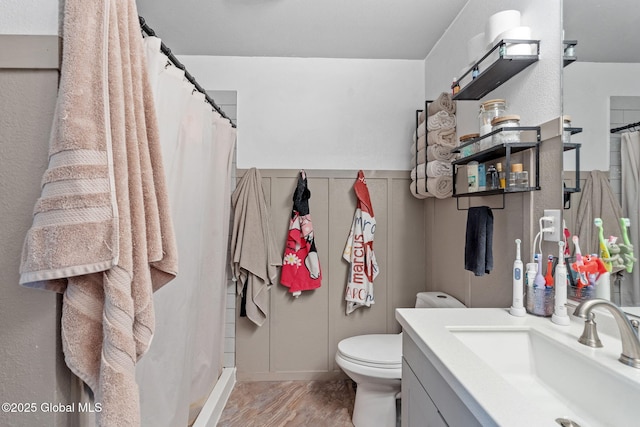full bath with vanity, a shower with shower curtain, and toilet
