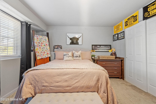 bedroom featuring carpet floors and baseboards